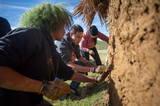 Hands-on experience to "mud" a traditional Choctaw winter home