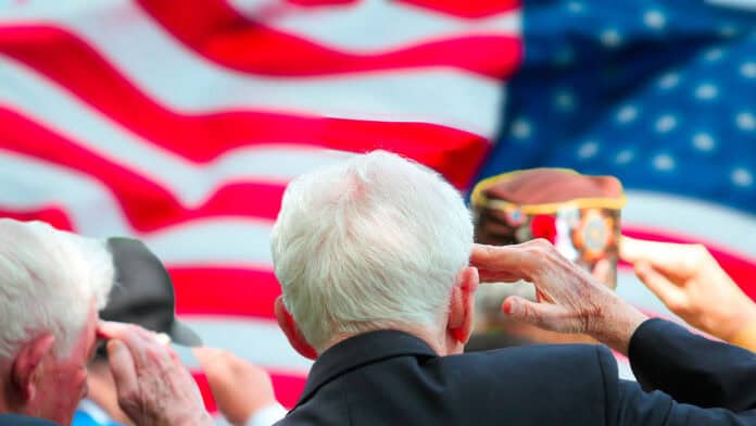 Veterans saluting the US flag for Veterans Day