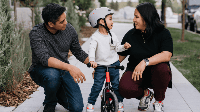 Family with child riding a bicycle