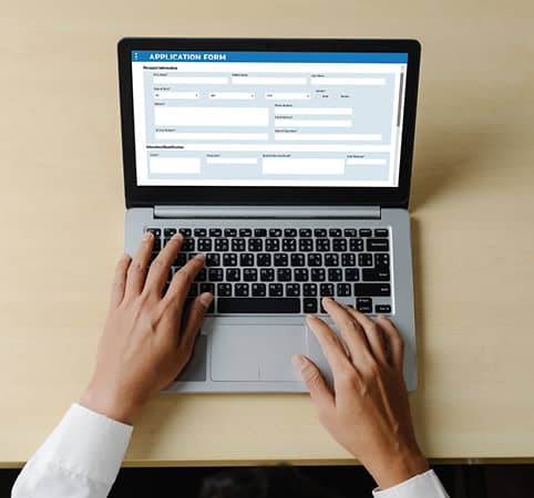 Filing out a form on a laptop